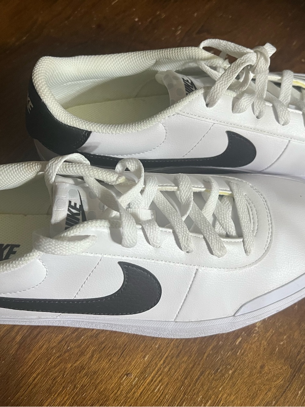 Nike White Sneakers with Black Swoosh Accent